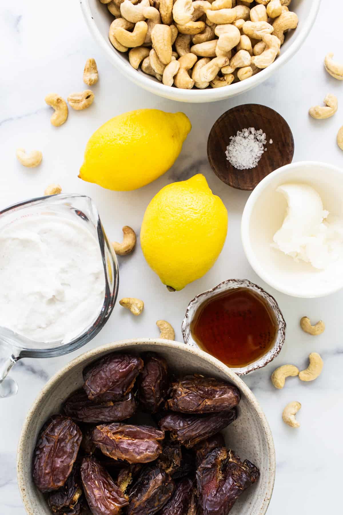 a bowl of dates, cashews, and lemons.