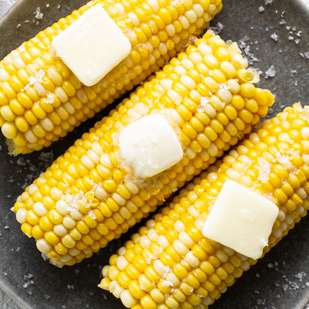 corn connected  the cob with food  and salt.