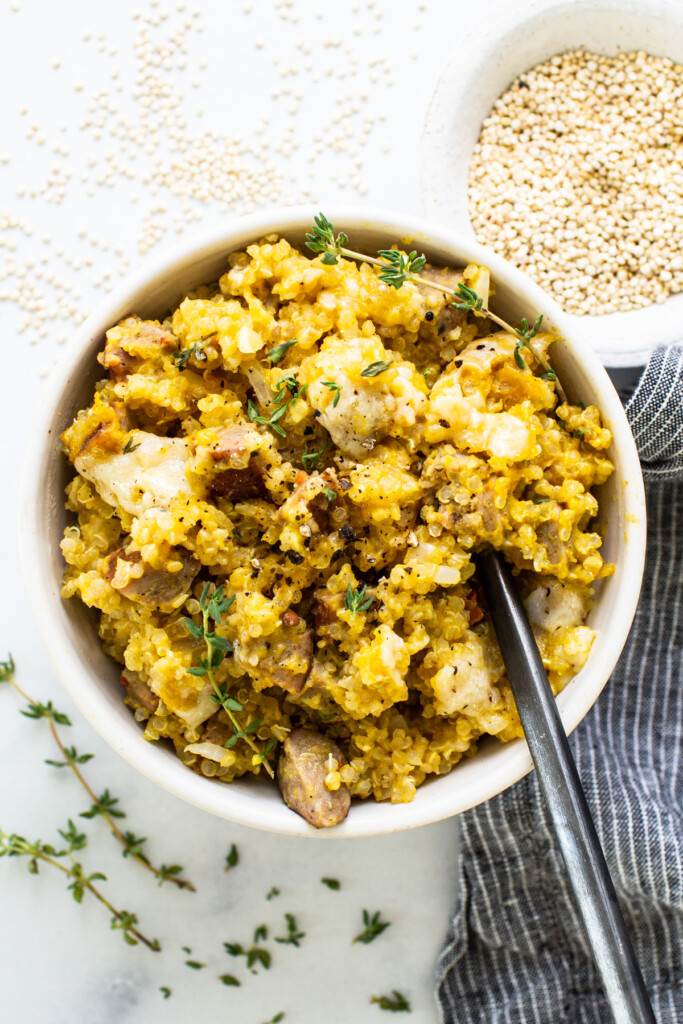 A bowl of couscous with mushrooms and thyme.