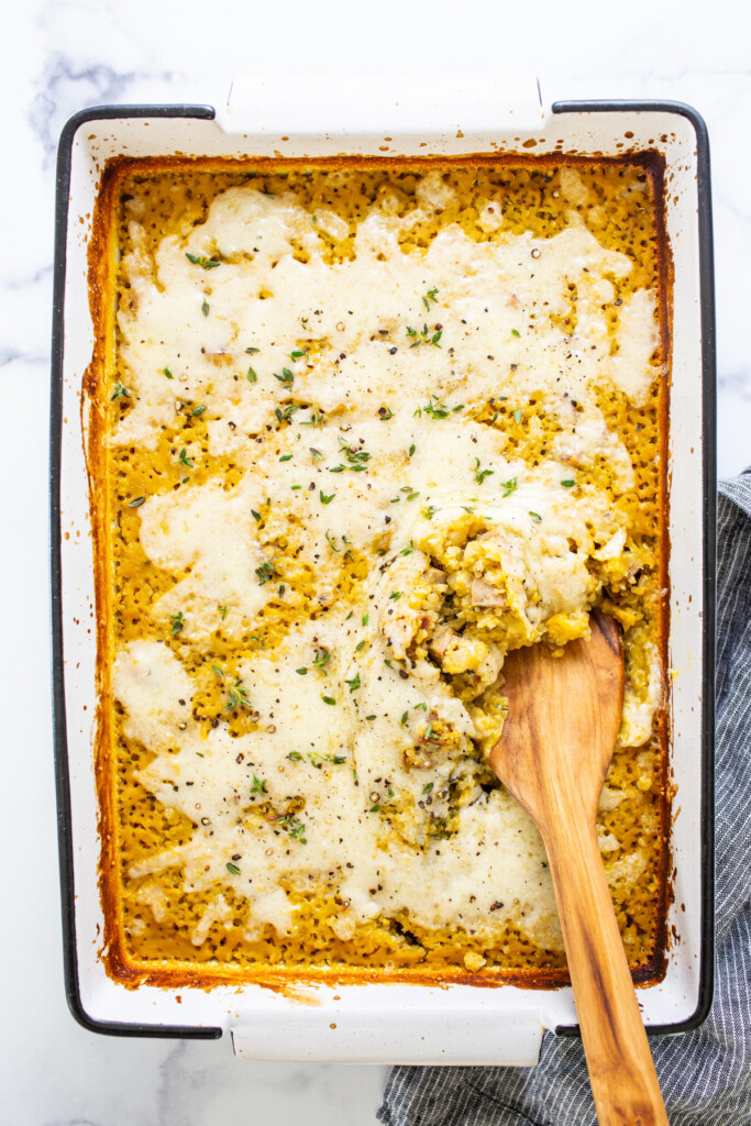 A casserole dish with a wooden spoon in it.