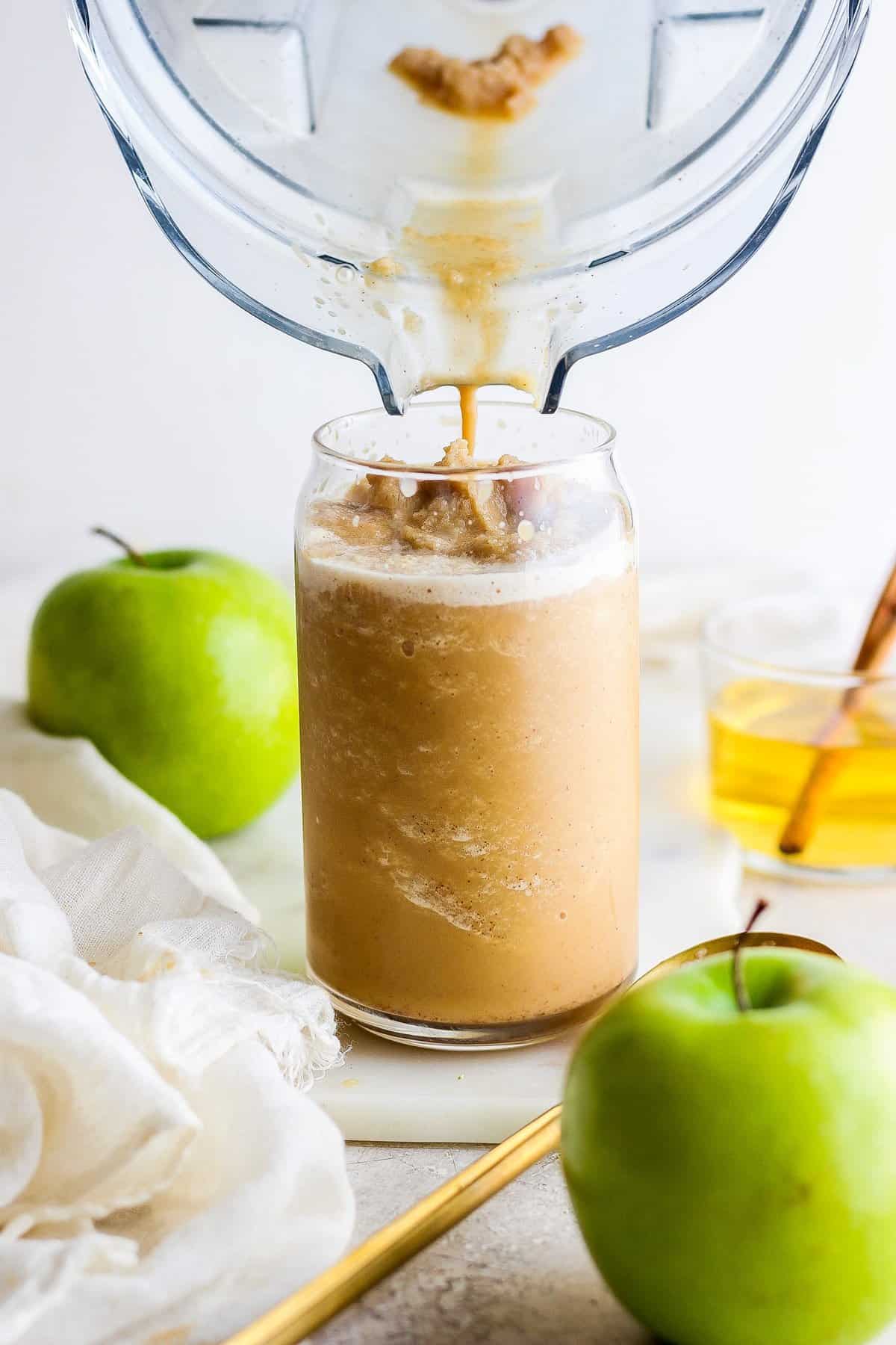 An apple juice being poured into a glass.