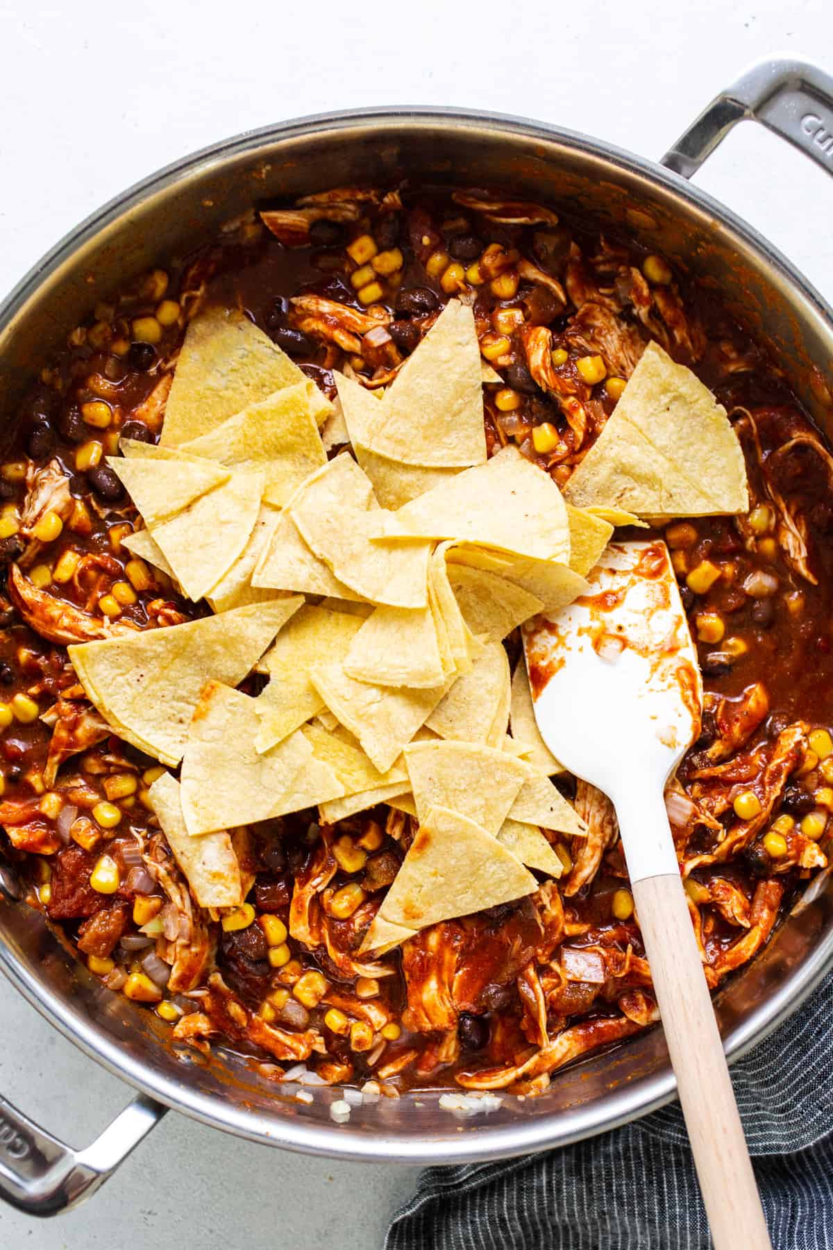 Mexican chicken enchilada in a pan with tortilla chips.