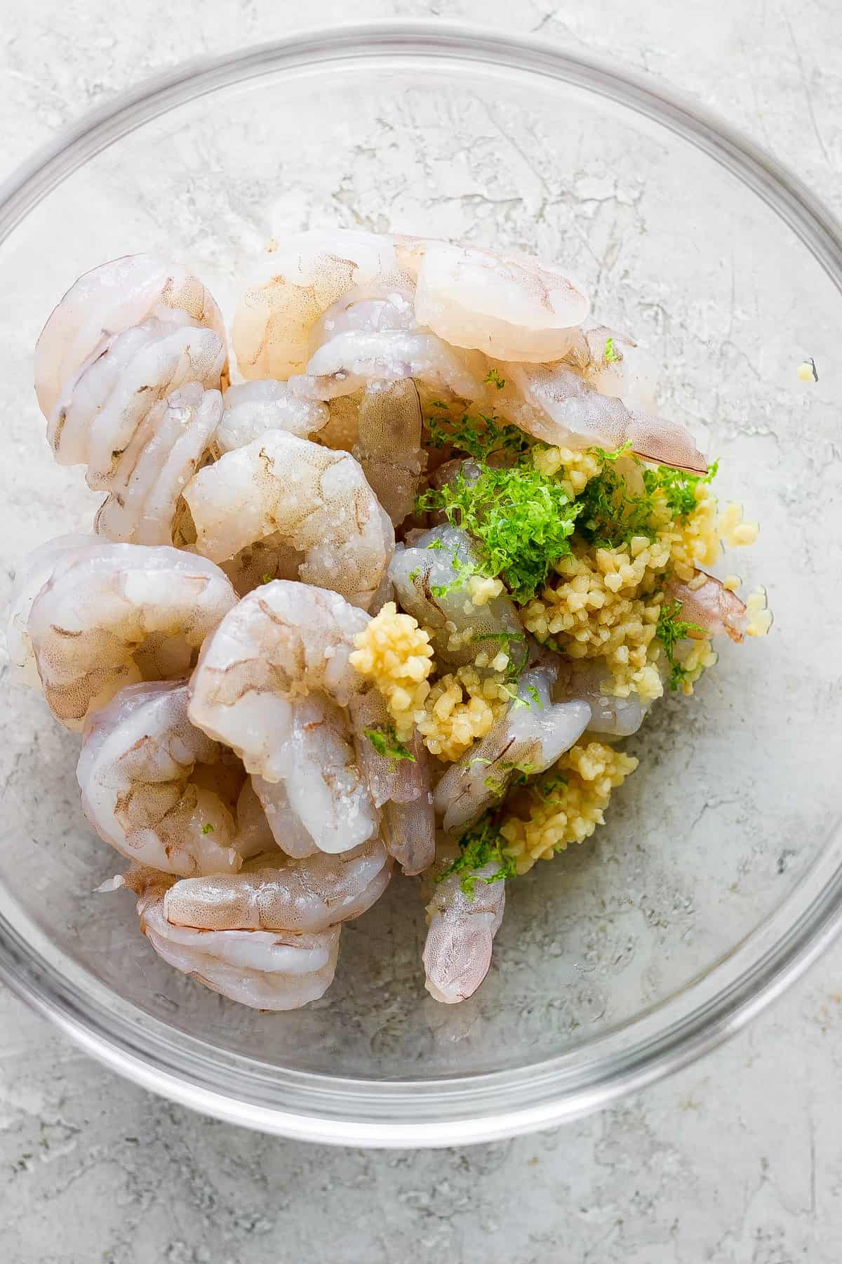 Prawns in a bowl with parsley and paprika.