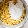 A pot of pasta with cream in it.