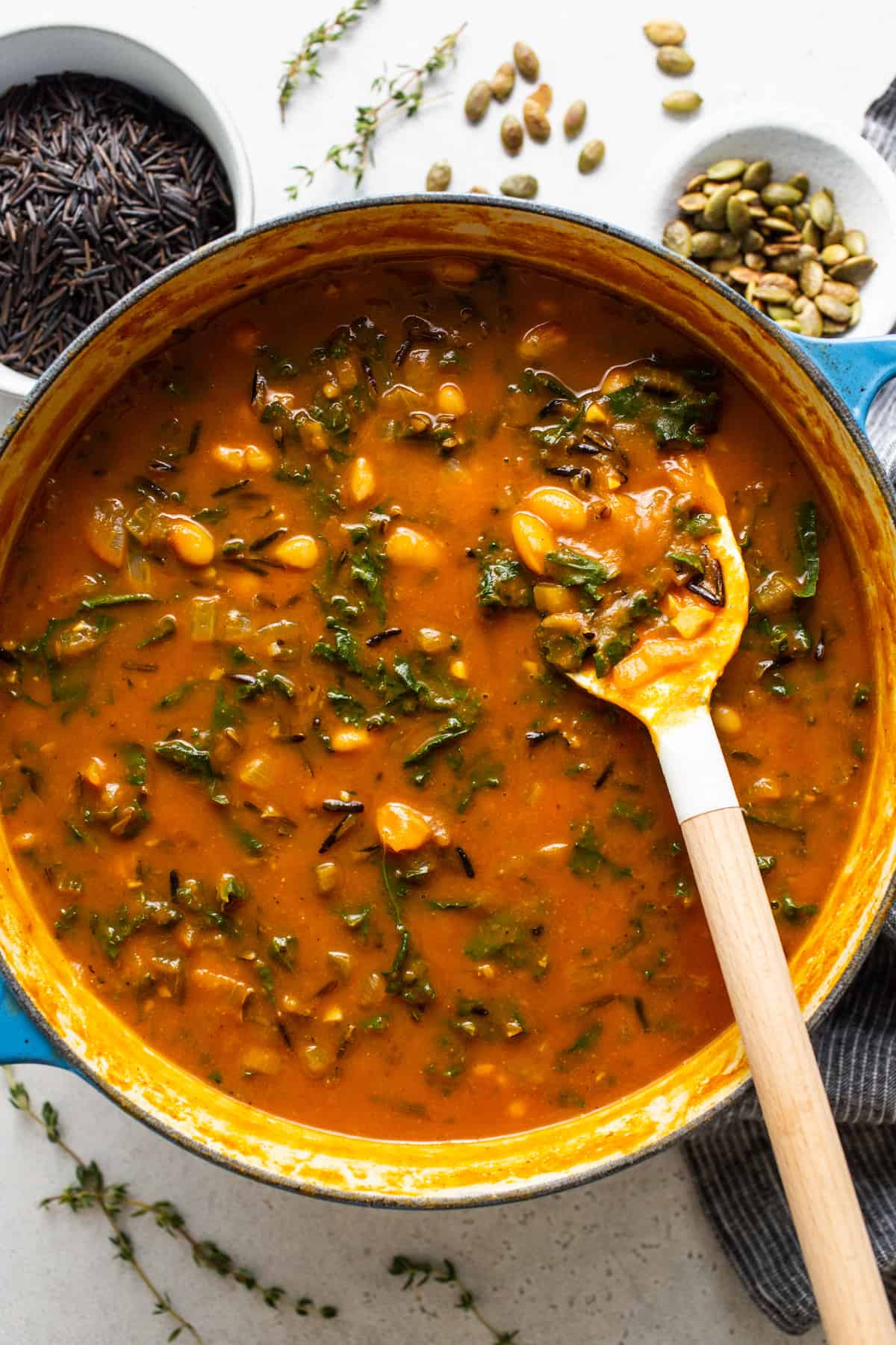 A pot full of soup with a spoon in it.