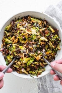 Brussels sprouts salad in a bowl with two forks.