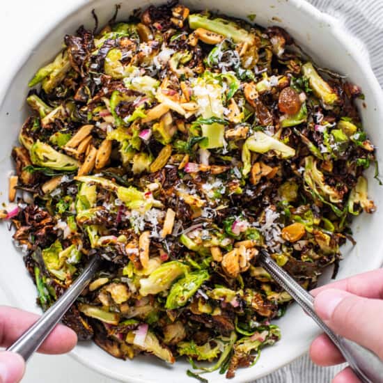 Brussels sprouts salad in a bowl with two forks.