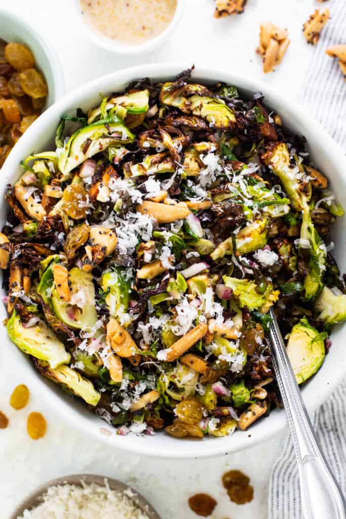 Brussels sprout salad in a white bowl.