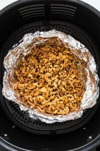 An air fryer filled with nuts.