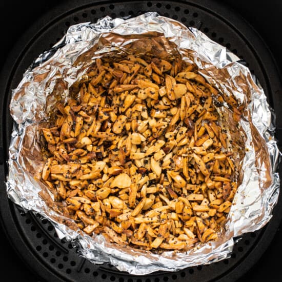 An air fryer filled with nuts.