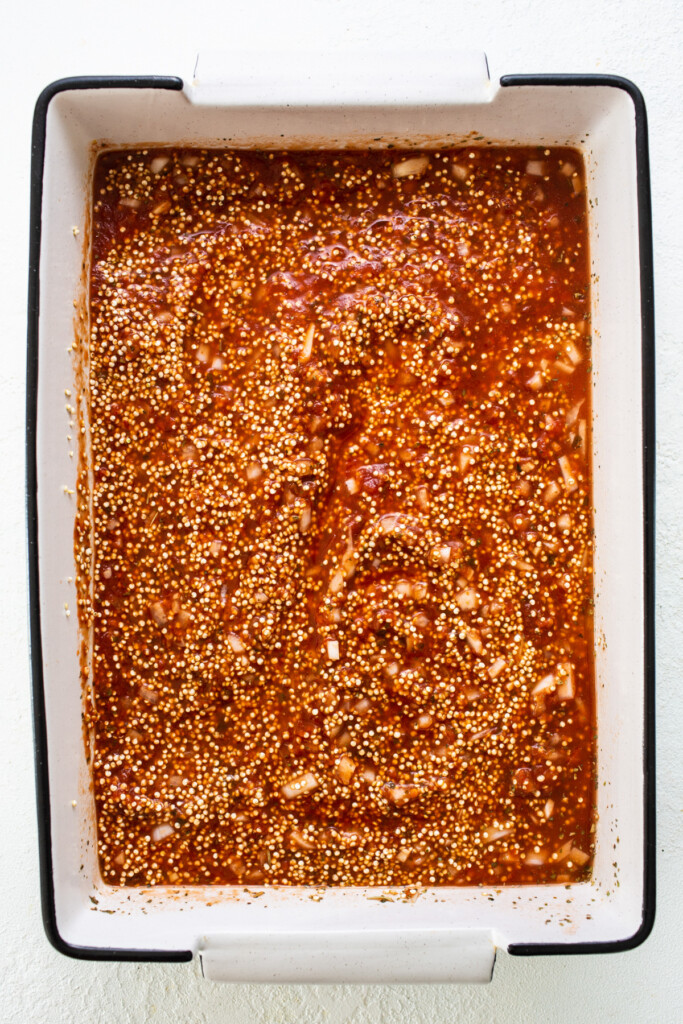 A baking dish filled with sauce and spices.