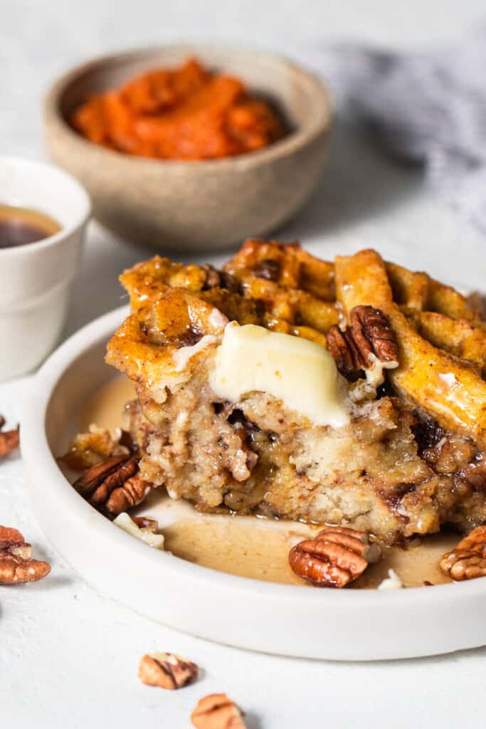 A plate with waffles and pecans on it.