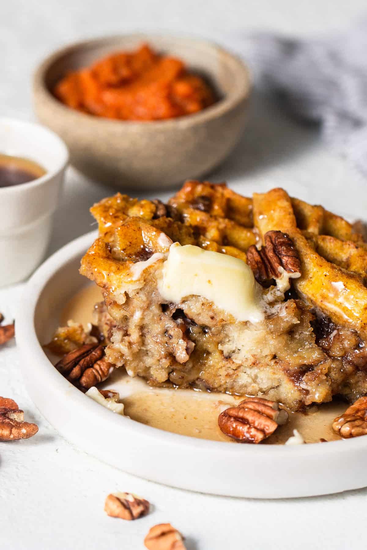 A plate with waffles and pecans on it.