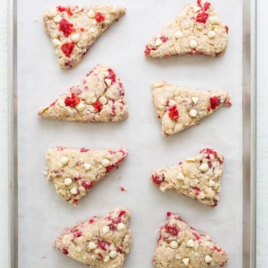 Cranberry almond scones on a baking sheet.