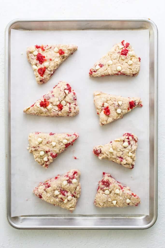 Cranberry almond scones on a baking sheet.