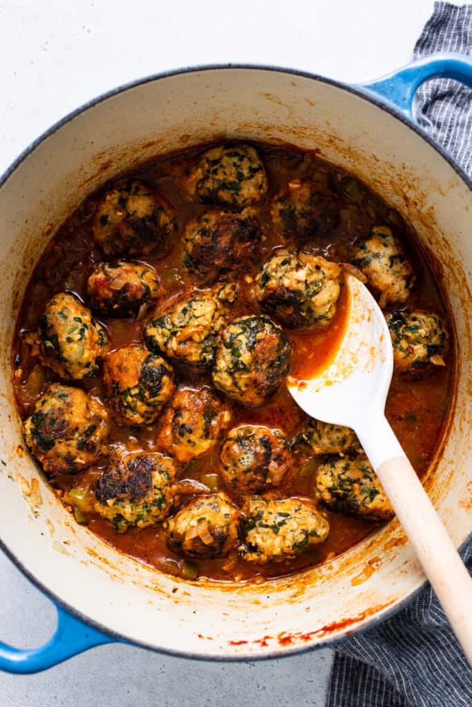 Meatballs in tomato sauce with a spoon.