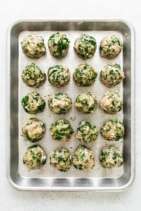 Spinach and mushroom meatballs on a baking sheet.