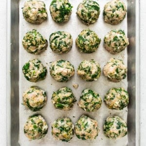 Spinach and mushroom meatballs on a baking sheet.