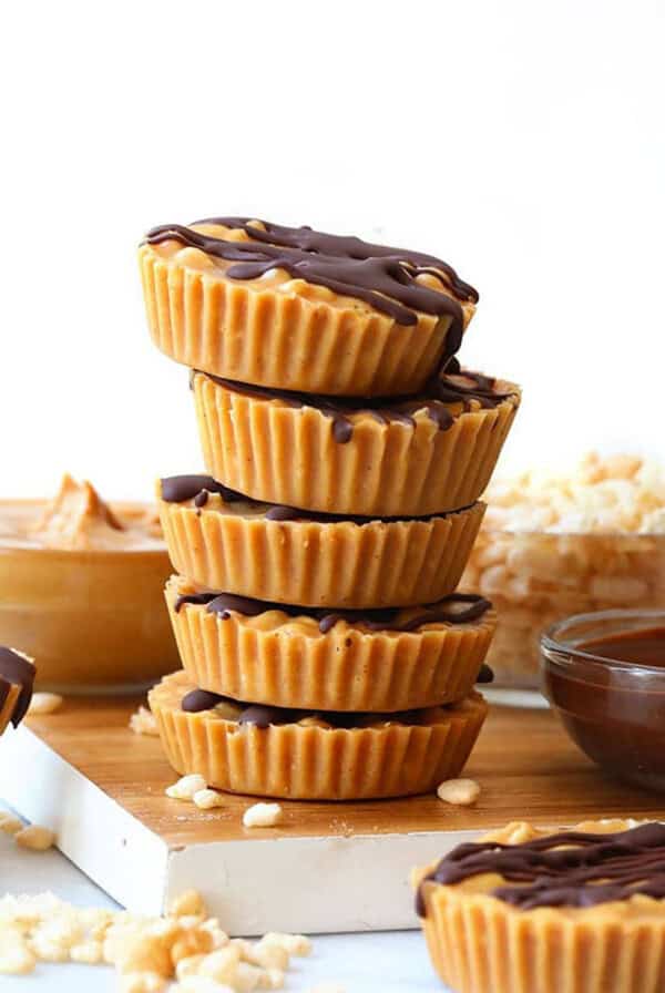 A stack of peanut butter cups on a cutting board.