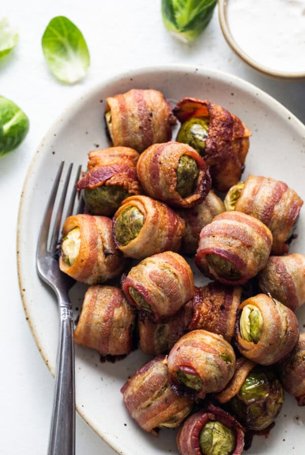 Bacon wrapped brussels sprouts on a plate.
