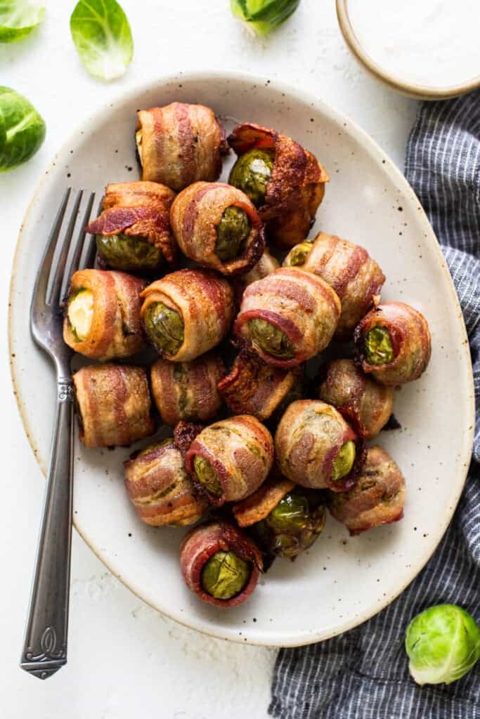 Brussels sprouts wrapped in bacon on a plate.