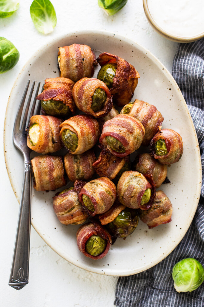 Brussels sprouts wrapped in bacon on a plate.