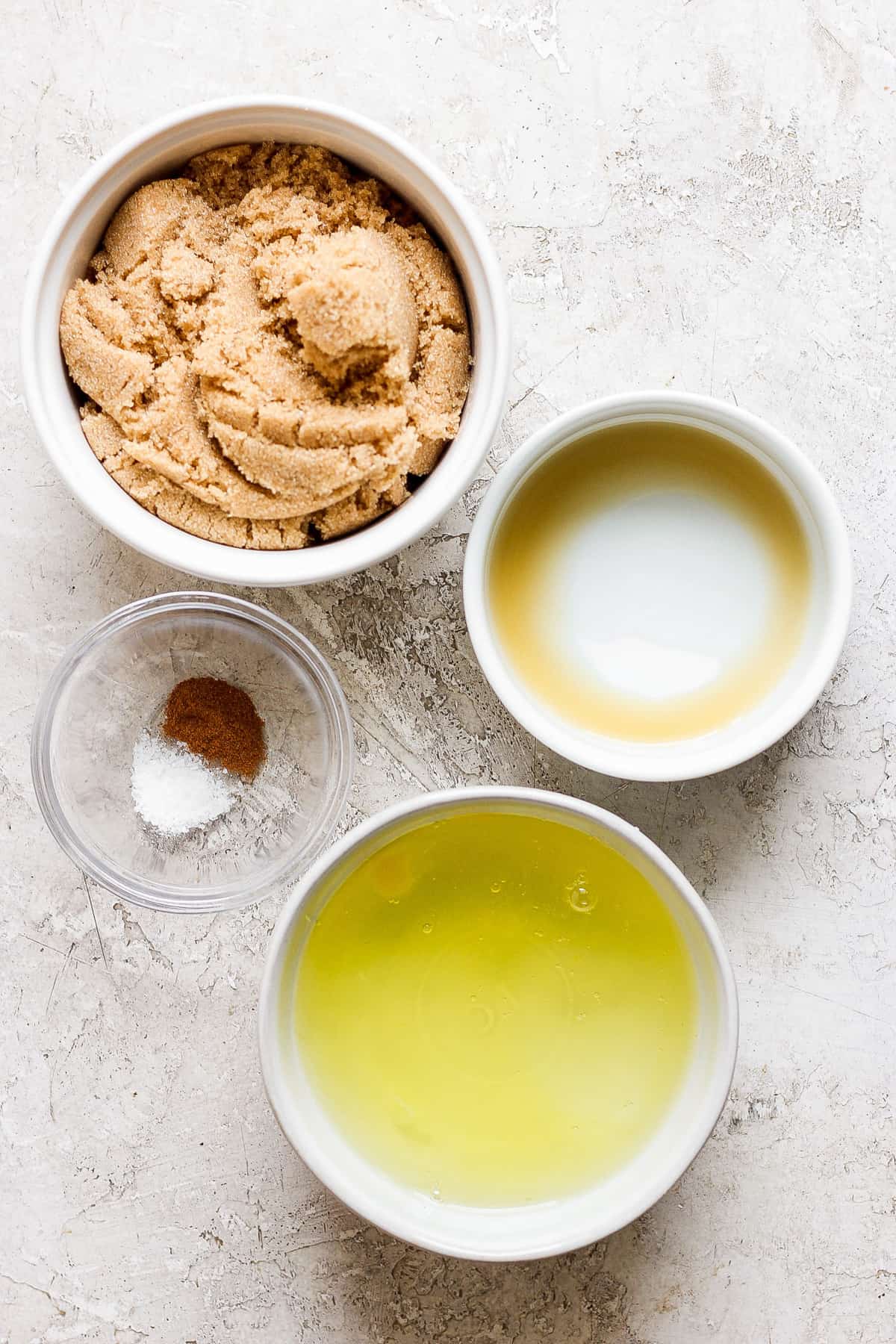 A bowl of peanut butter, olive oil, and salt on a white surface.