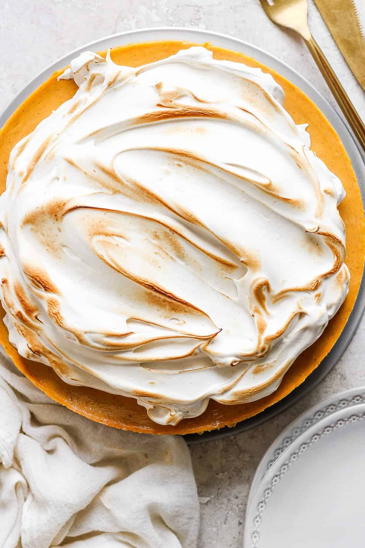 A pie with meringue topping on a plate.