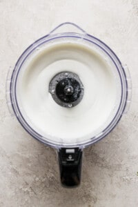 A bowl of yogurt in a blender with a lid.