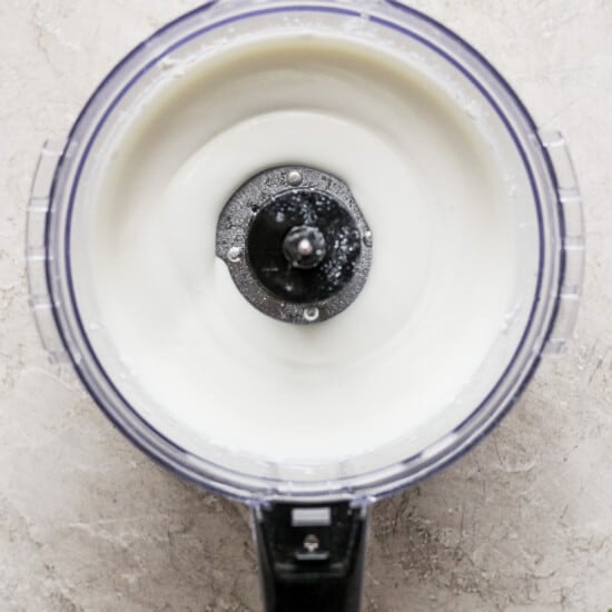 A bowl of yogurt in a blender with a lid.