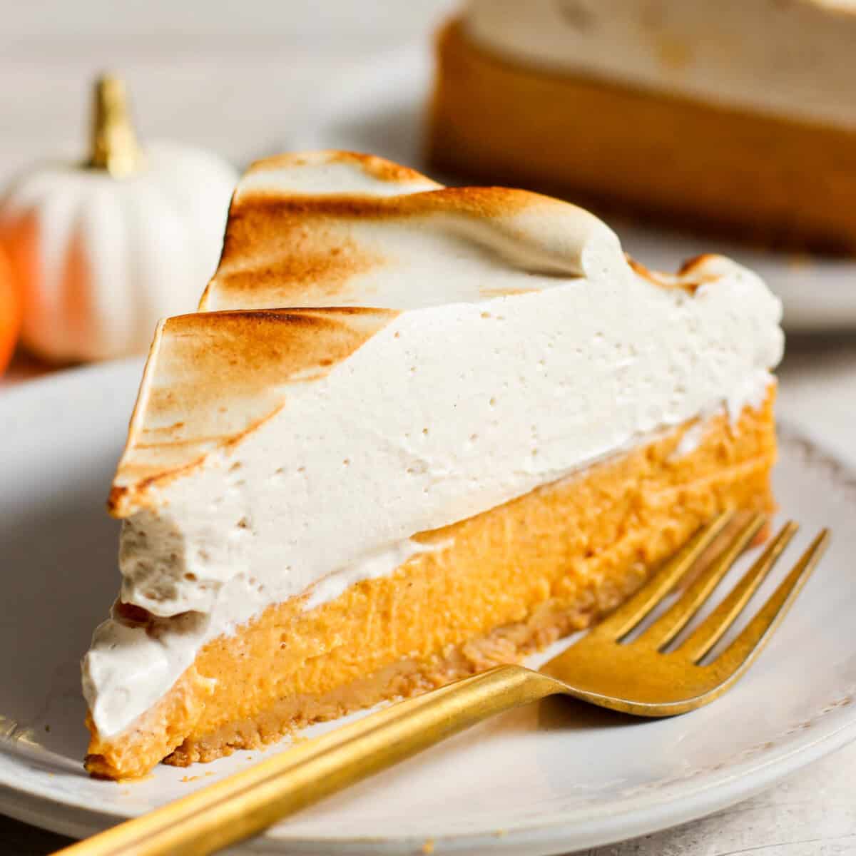 A portion    of pumpkin pastry  connected  a sheet  with a fork.