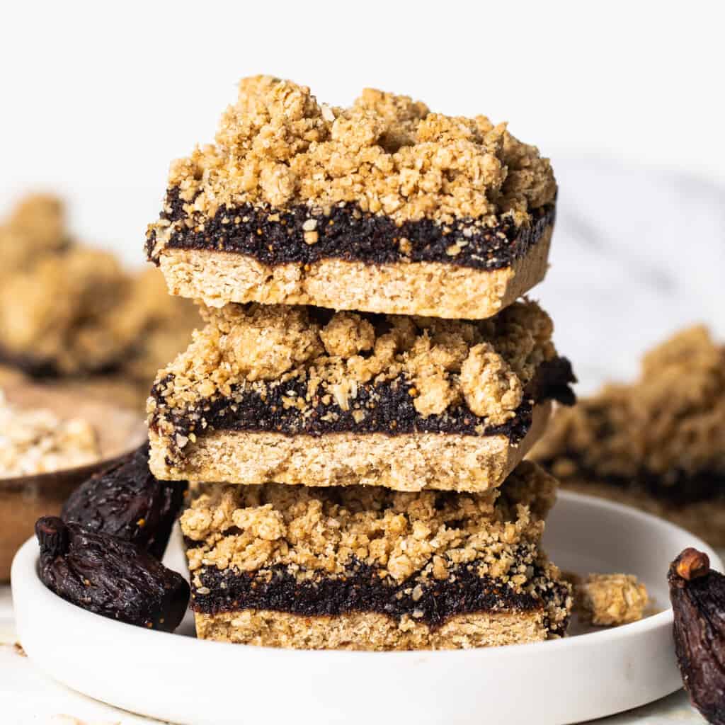 A stack of fig bars on a plate.