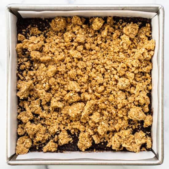 A baking pan with a layer of granola in it.