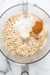 Oats, cinnamon, and other ingredients in a mixing bowl.