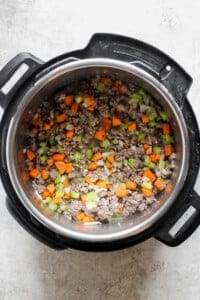 An instant pot filled with meat and vegetables.