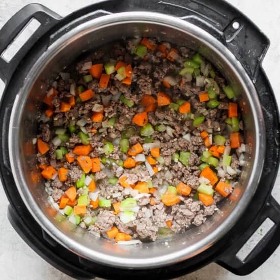 An instant pot filled with meat and vegetables.