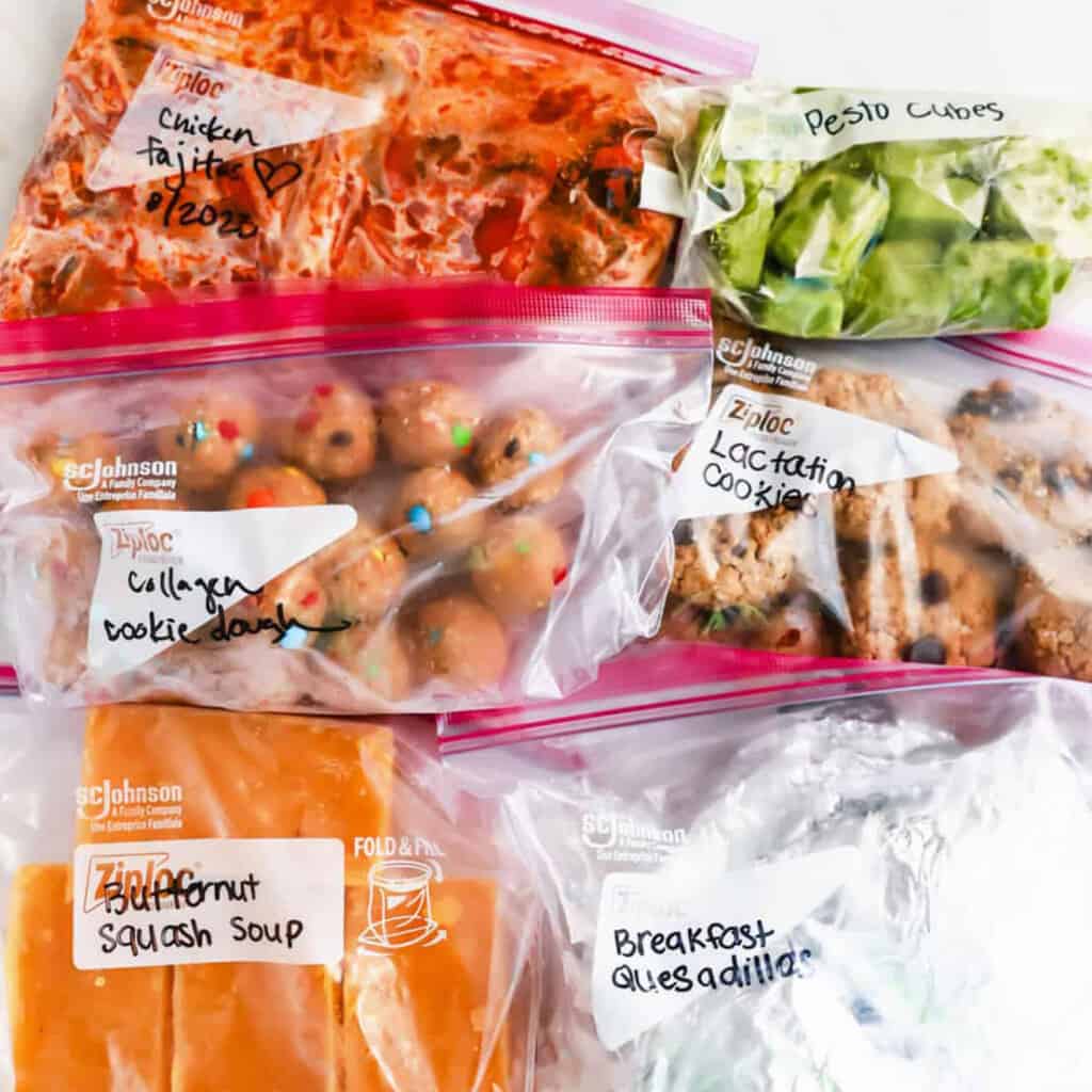 A variety of food in plastic bags on a table.