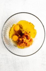 Two eggs in a glass bowl on a white background.