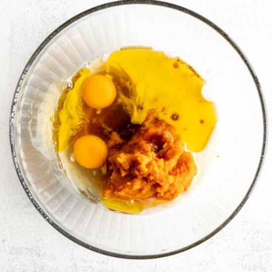 Two eggs in a glass bowl on a white background.