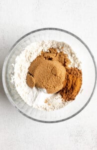 A glass bowl with cinnamon, sugar and flour in it.