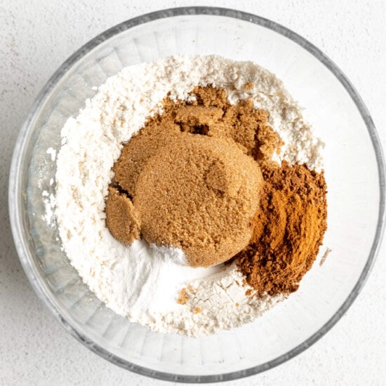 A glass bowl with cinnamon, sugar and flour in it.
