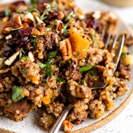A dish with quinoa and nuts on top.