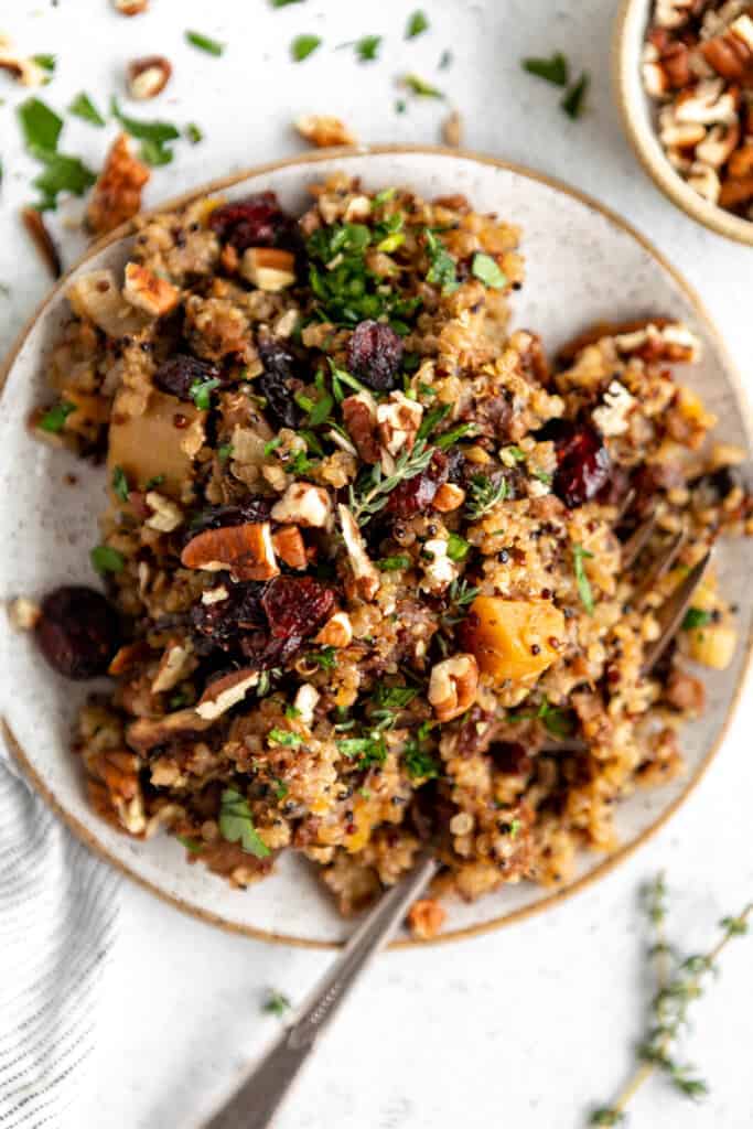 Quinoa with cranberries and nuts on a plate.