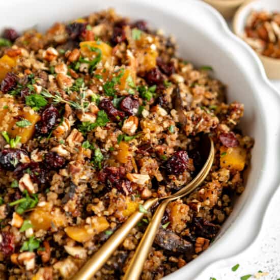 Quinoa with cranberries and nuts in a white bowl.