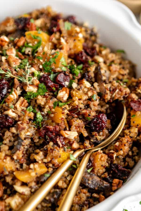 Quinoa with cranberries and nuts in a white bowl.