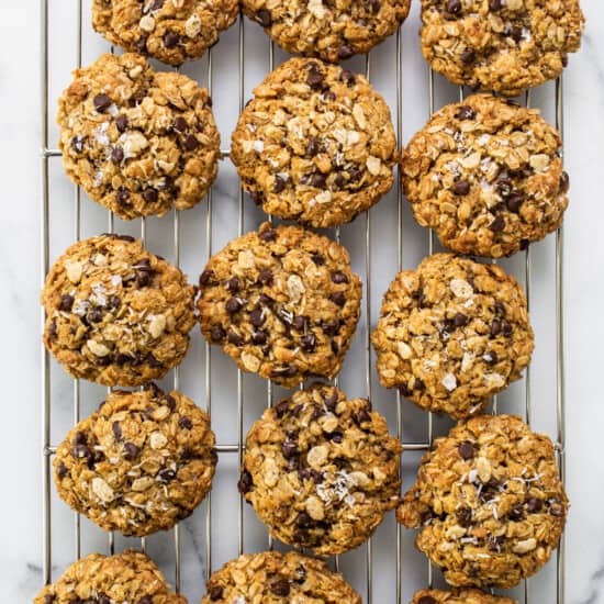 Chocolate chip oatmeal cookies on a cooling rack.