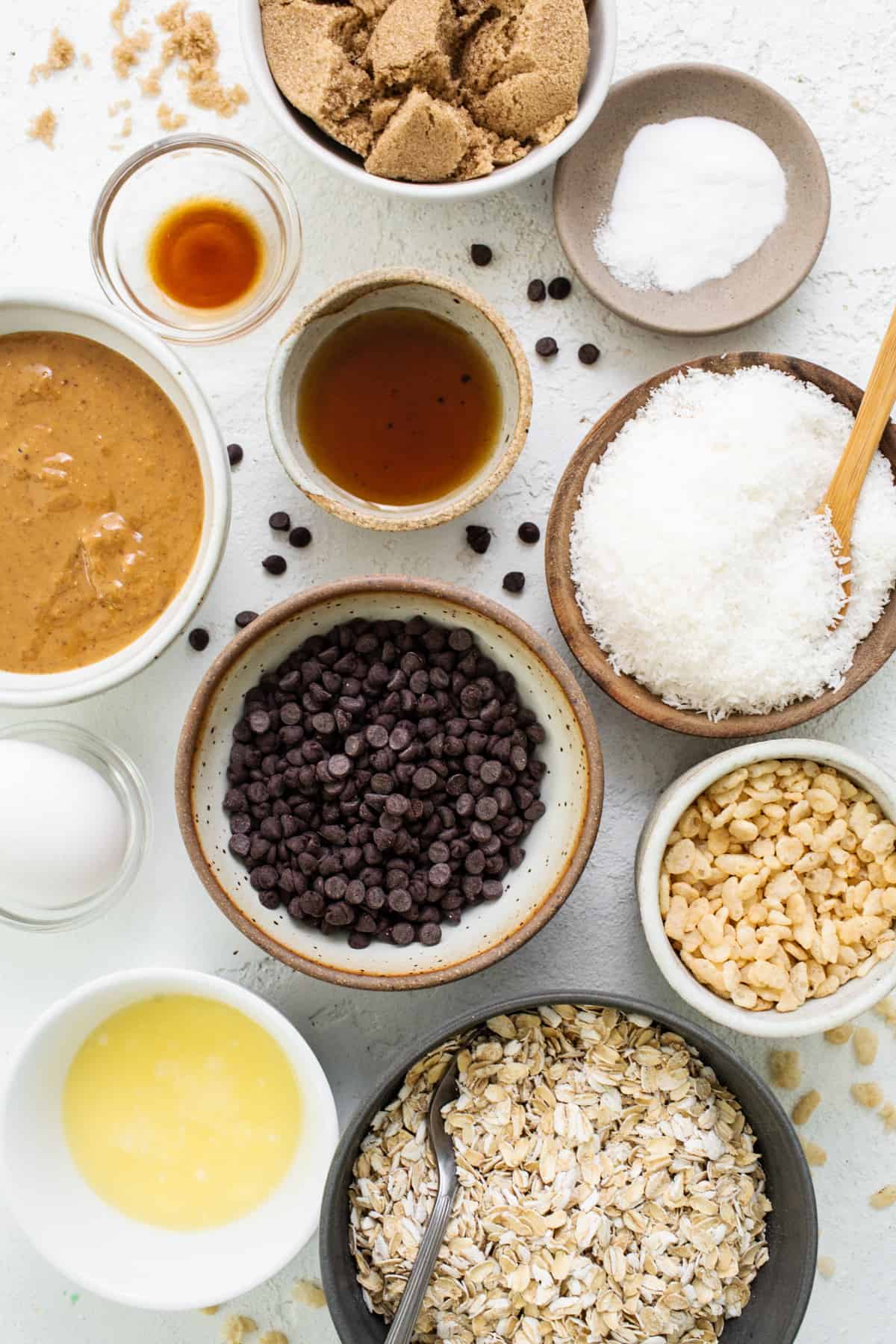 A bowl of oatmeal, chocolate chips, peanut butter, and other ingredients.