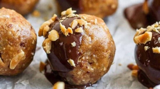 A plate of fit and indulgent chocolate covered peanut butter balls.