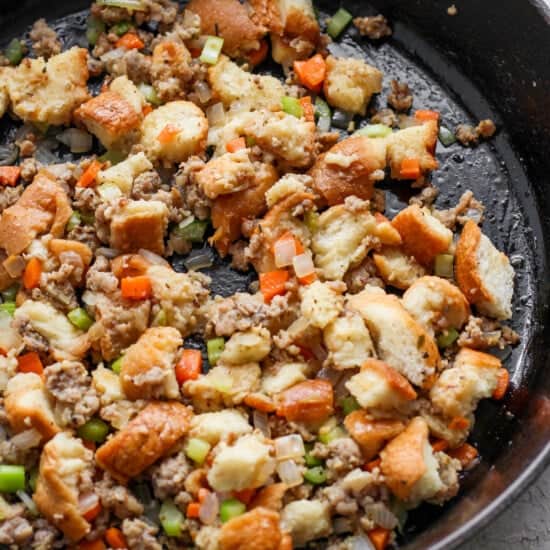 A skillet filled with stuffing and vegetables.