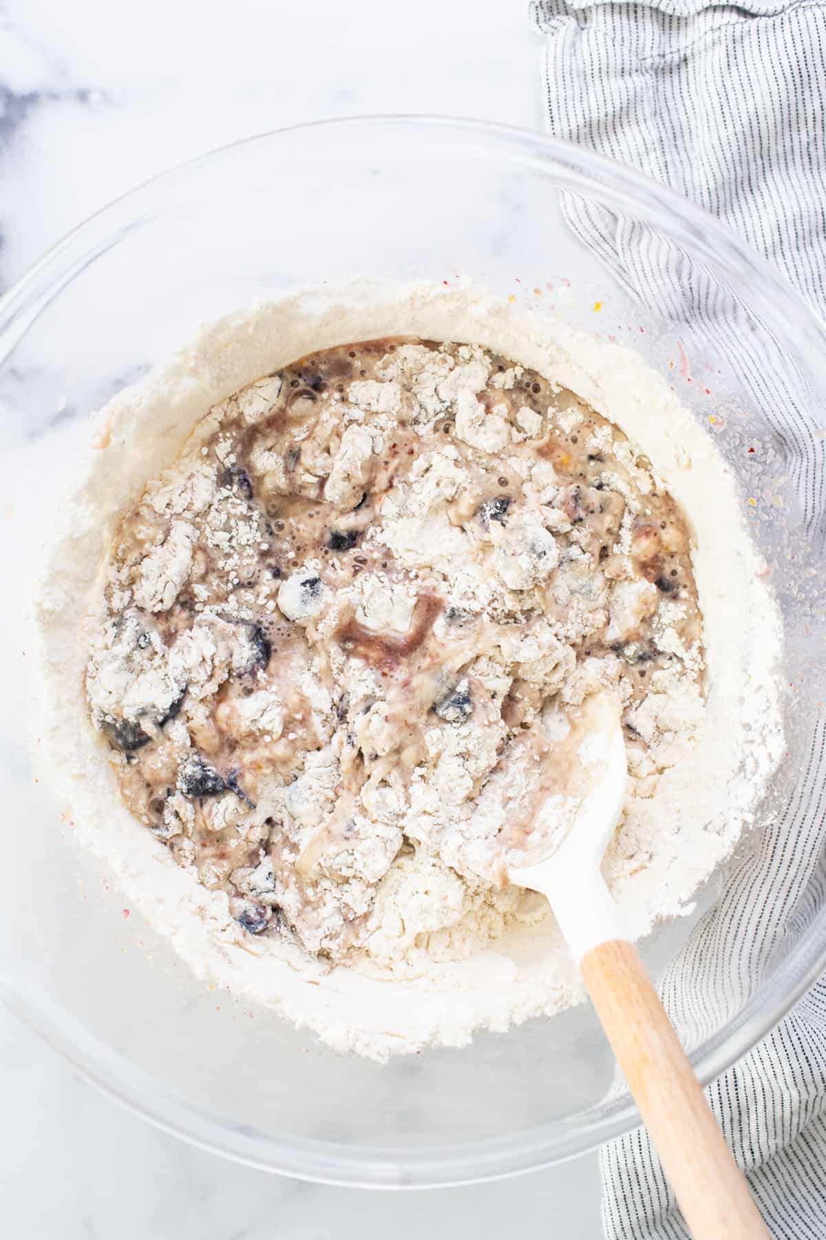 A bowl of oats with a wooden spoon in it.